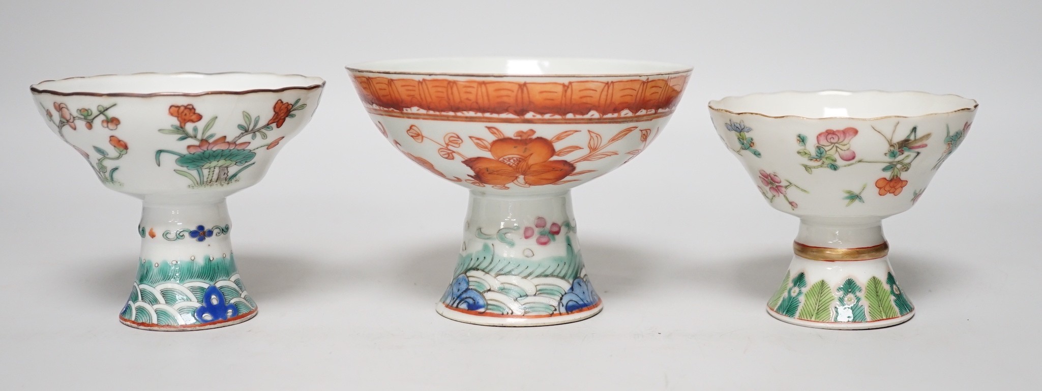 Three 19th century Chinese stem cups, painted with insects, flowers, bats and peaches, largest 9cm